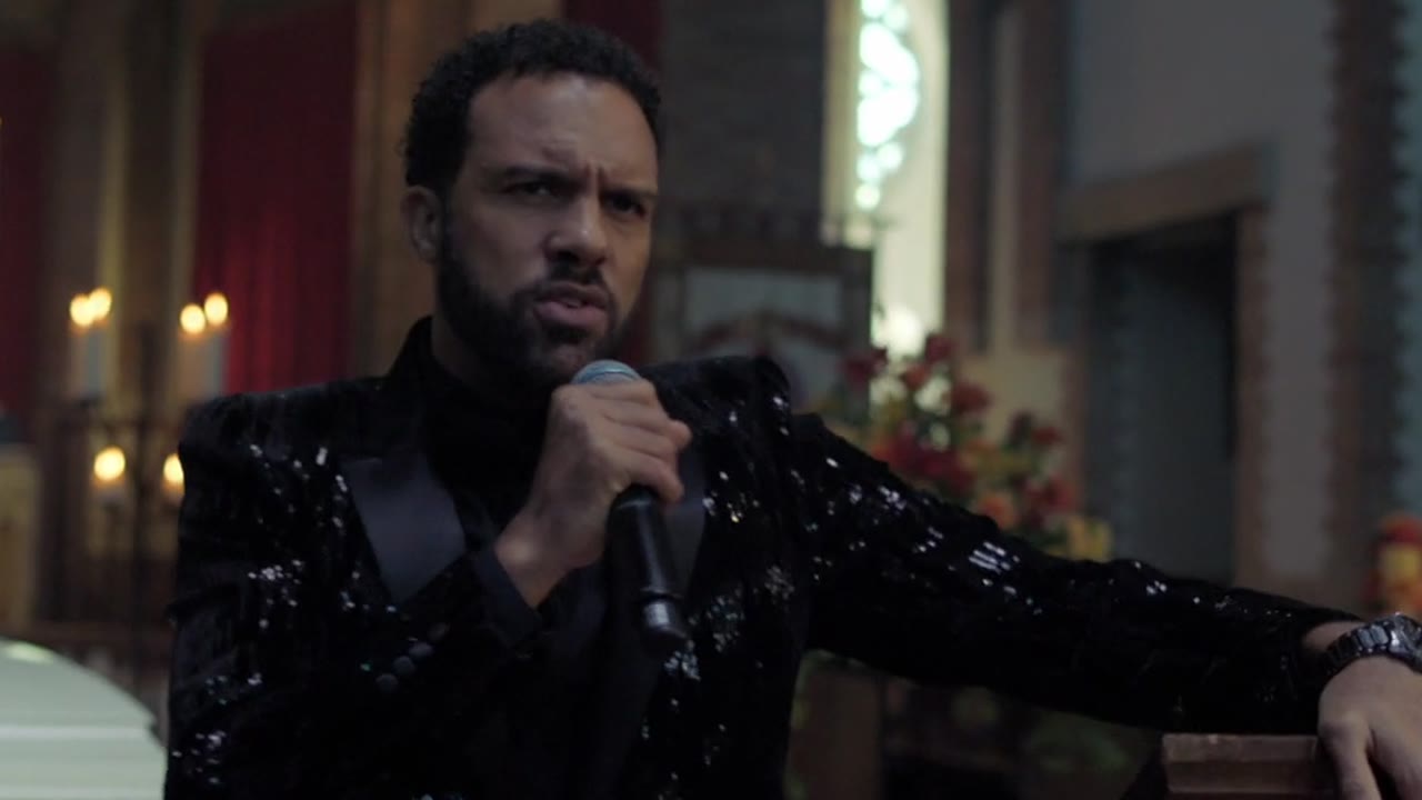 O-T Fagbenle as Maxxx, singing at a funeral